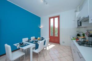 a kitchen and dining room with a table and chairs at Residenza Oleandro Lake View Luino Center in Luino