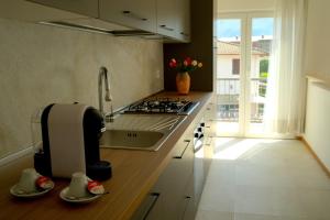 多马索CASA PAOLA Central Stay by the Lake的带水槽和炉灶的厨房 顶部烤箱 更多23张照片