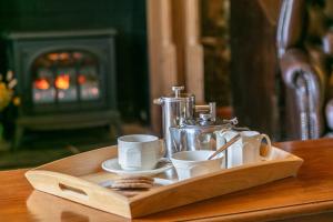 a wooden tray with cups and a coffee maker on a table at East Hook Farmhouse in Haverfordwest