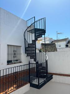 a spiral staircase on the side of a building at Asís 20 in Medina Sidonia
