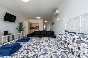 Un dormitorio con una cama grande y un sofá. en T0 Vilamoura Downtown, en Vilamoura