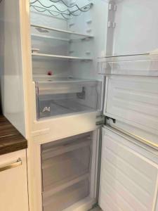 an empty refrigerator with its door open in a kitchen at Apartment II für 4 Aalen I Wlan I Netflix in Aalen