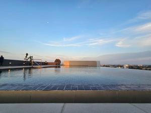 a large swimming pool on top of a building at Lovely Podium CityView 3Bedroom with Pool A2 in Kuching