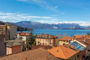 a city with a view of a lake and mountains at Appartamento Il Golfo Lake View - Happy Rentals in Laveno +17 photos
