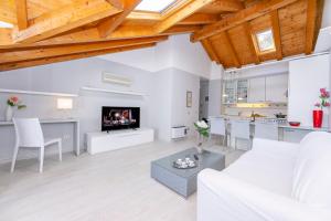een woonkamer met een witte bank en een tafel bij Blu Lake apartment on Ghiffa Beach in Ghiffa