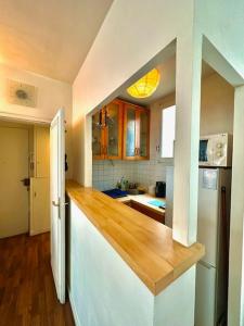 a kitchen with a wooden counter top in a room at Cozy 1BR in the Heart Of Paris in Paris