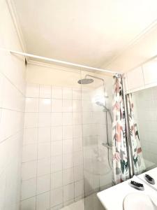 a bathroom with a shower and a sink at Cozy 1BR in the Heart Of Paris in Paris