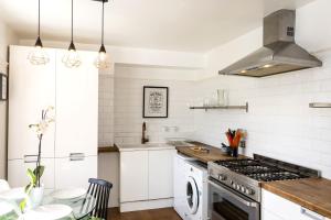 a kitchen with white walls and a stove top oven at Seaside Hideout - close to beach in Eastbourne