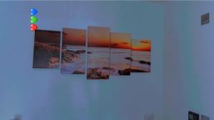 a group of pictures of the ocean on a wall at Absolute Stays at The Ridgmont-St Albans-High Street- Near Luton Airport - St Albans Abbey Train station -Close to London- Harry Potter World - The Odyssey Cinema-Contractors -London Road-Business-Leisure in St. Albans