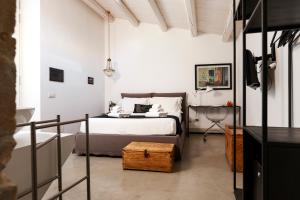 a bedroom with a bed and a tub in a room at Embrace Sicily Guest House in Noto