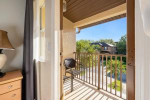 a balcony with a chair and a view at Resort w Lazy River and Arcade 30mis to Disney in Davenport