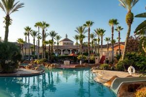 a resort with palm trees and a swimming pool at Resort w Lazy River and Arcade 30mis to Disney in Davenport