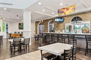 a restaurant with tables and chairs and a bar at Resort w Lazy River and Arcade 30mis to Disney in Davenport
