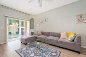 a living room with a couch and a glass table at Resort w Lazy River and Arcade 30mis to Disney in Davenport