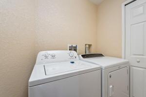 a white washer and dryer in a room at Resort w Lazy River and Arcade 30mis to Disney in Davenport