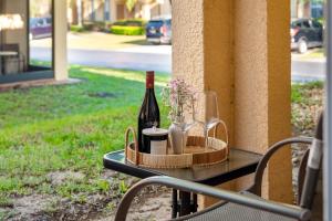 a tray with a bottle of wine and two glasses at Resort w Lazy River and Arcade 30mis to Disney in Davenport
