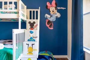 a room with a mickey mouse wall decal at Resort w Lazy River and Arcade 30mis to Disney in Davenport