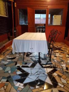 a table and chairs on a floor with mosaic tiles at Bungalow Chez Mouch Nosy Be 7 in Nosy Be