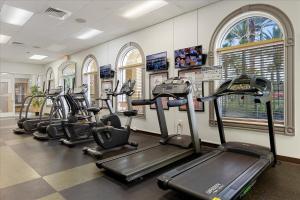 a row of exercise bikes in a gym at Resort w Lazy River and Arcade 30mis to Disney in Davenport