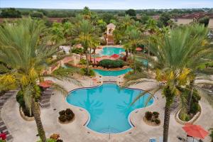 an overhead view of a resort pool with palm trees at Resort w Lazy River and Arcade 30mis to Disney in Davenport