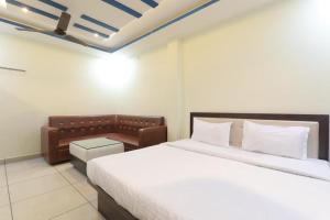 a bedroom with a large bed and a couch at SHREE Ram hotel in Gorakhpur