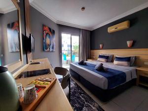 una camera d'albergo con letto e tavolo con bancone di Summer rose hotel a Side