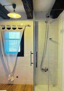 a bathroom with a shower with a glass door at Cal Xeco in Montsonis