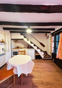 a living room with a table and a staircase at Cal Xeco in Montsonis