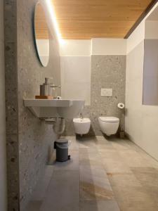 a bathroom with a sink and a toilet at Dalù houses in Tirano