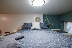 a large bed in a bedroom with blue walls at Ultimate Urban living at Centrally Located Lofts in New York