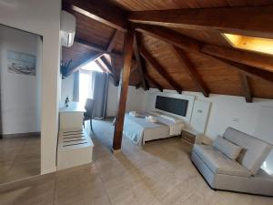 a bedroom with a bed and a couch in a room at Blue Marine - Free Parking in Tropea