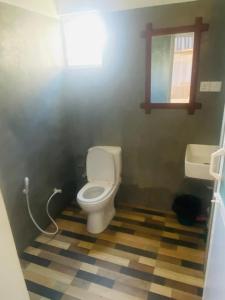 a bathroom with a toilet and a sink at Charle's House Ahangama in Ahangama