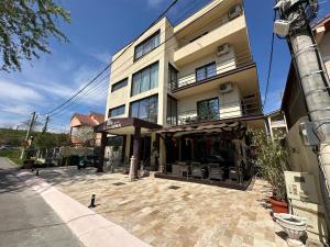 a tall building with a patio in front of it at Casa Roma in Mamaia Nord