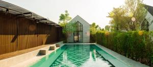 a swimming pool in the backyard of a house at Phuping Valley Resort in Tak