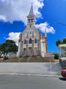 a building with a steeple with a clock on it at Hotel Rio Branco in Jequié