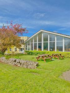 a picnic table in front of a building at Fernhill Lodge Carrigaline in Cork