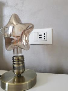 a light switch with a glass head on a table at Bologna Holiday House in Bologna