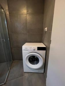 a washer and dryer in a small bathroom at Apartmán Melissa in Žilina