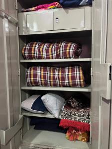a walk in closet with pillows and blankets at Dreamy bungalow 2BHK apartment in Mysore