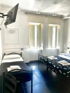 una camera con due letti e una tv di Palace Rome a Roma