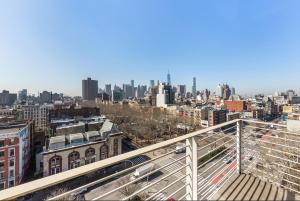 a view of the city from the balcony of a building at Delancey Tower in New York
