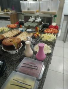 a buffet of food on a counter in a kitchen at Hotel Rio Branco in Jequié +24 photos