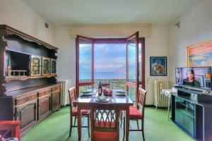 a dining room with a table and a large window at La Finestra Sul Lago - Happy Rentals in Stresa