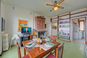 a dining room with a table and a television at La Finestra Sul Lago - Happy Rentals in Stresa