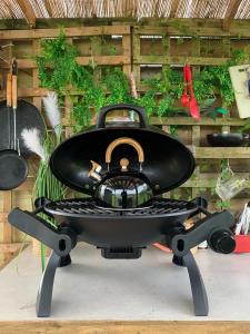 a bbq grill sitting on top of a table at Forest Glamping Retreat in Blakeney
