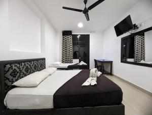 Postel nebo postele na pokoji v ubytování Big John Hotel