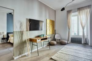 a living room with a desk and a bedroom at Clausim Domus: new brightful flat next to the Vatican in Rome