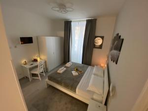 a small bedroom with a bed and a desk at Soft rooms ROMA CENTRO Guest house affittacamere in Rome