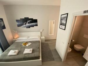 a small bedroom with a bed and a bathroom at Soft rooms ROMA CENTRO Guest house affittacamere in Rome