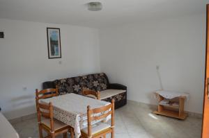 a living room with a table and a couch at Apartman Seka in Senj